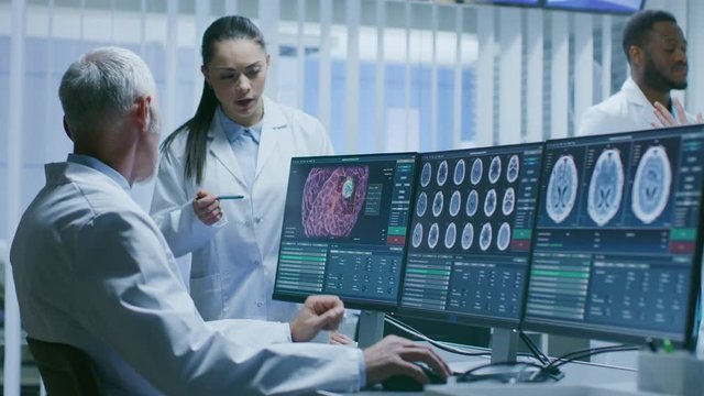 Two Medical Scientists in the Brain Research Laboratory Discussing Progress on the Neurophysiology Project Fighting Tumors.  Shot on RED EPIC-W 8K Helium Cinema Camera.