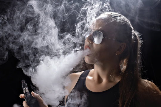 Girl soars on a black background vape