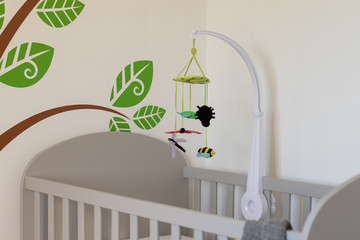 Mobile hanging over a baby cot 