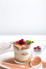 Tiramisu in a glass cup. Vertical orientation