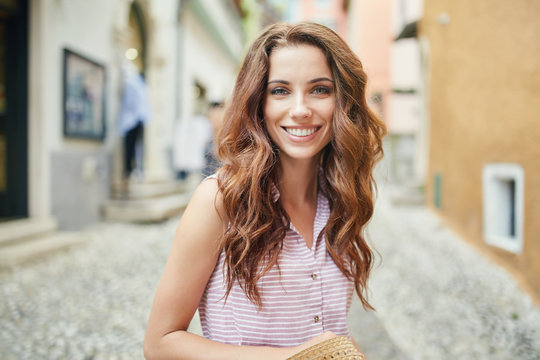 Fototapeta Young beautiful woman walking the streets of an Italian town