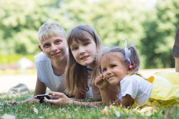 three children with a phone