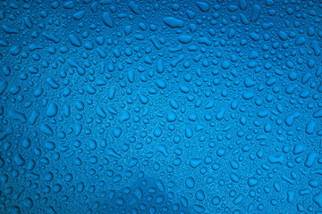 Rain drops on a blue smooth surface.