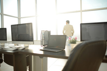 Modern office space with tables and office supplies.