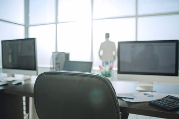 Modern office space with tables and office supplies.