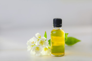 Essence of flowers on white background in beautiful glass jar