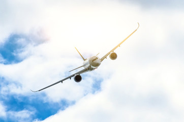 Passenger airplane flies through the turbulence zone through the lightning of storm clouds in bad weather.