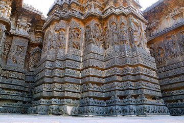 View of ornate wall panel relief in a stellate form of shrine, Hoysaleshwara temple, Halebidu, Karnataka. View from South West. - obrazy, fototapety, plakaty
