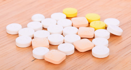 Fototapeta na wymiar pills on a wooden background