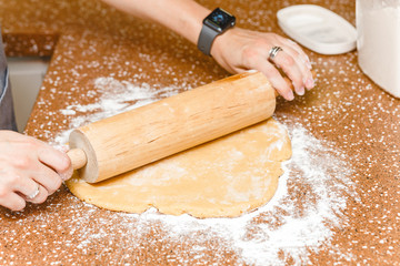 Housewife rolling out dough on kitchen table, cooking and baking recipe for pie