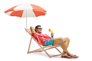 Tourist with a cocktail sitting in a deck chair with an umbrella - obrazy, fototapety, plakaty