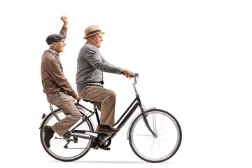 Two cheerful elderly men riding a bicycle together