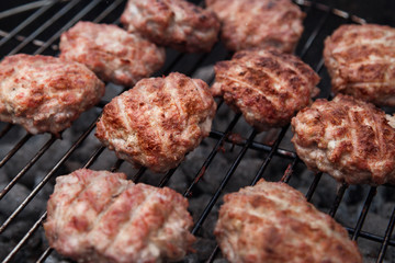 Burger Grilling on Fire. Homemade Hamburgers. Grill Meatballs. Making Hamburgers on a Grill Outdoor. 