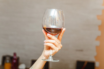 Woman hand holding Red wine in glass