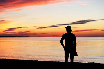 Silhouette of man with the camera and sunset. Photographer and sunset. Lake Ontario. Rochester, USA