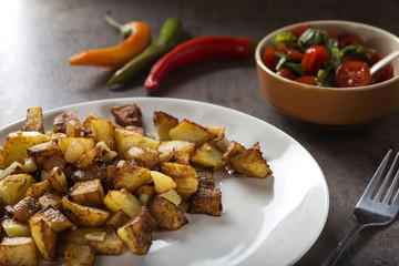 Fries with small pieces of fat pork meat, onion and garlic