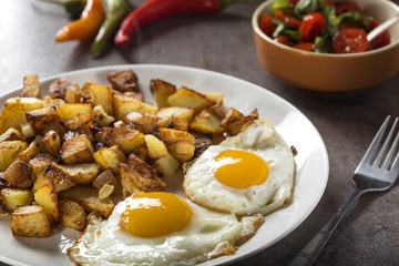 Eggs and Fries with small pieces of fat pork meat, onion and garlic