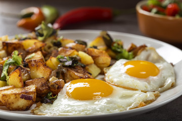 Eggs and Fries with small pieces of fat pork meat, onion and garlic
