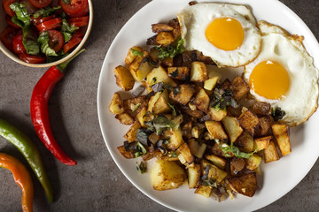 Eggs and Fries with small pieces of fat pork meat, onion and garlic on plate
