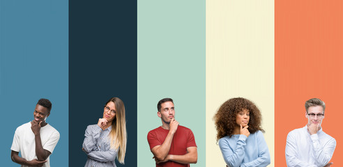 Group of people over vintage colors background looking confident at the camera with smile with crossed arms and hand raised on chin. Thinking positive.