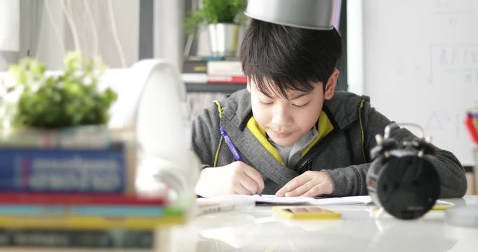 Young asian teenage student doing homework at home, Dolly move left to right.