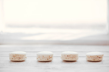 Colorful macaroons on a white desks