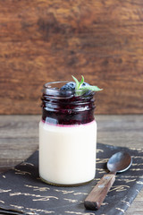 Coffee panna cotta with berry coulis and fresh blueberries. Delicious Italian dessert panna cotta