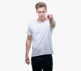 Young handsome blond man pointing with finger to the camera and to you, hand sign, positive and...