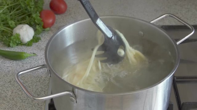 Preparing   A Spaghetti In A Steel Pot.