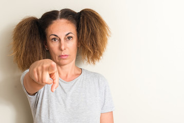 Brazilian woman wearing pigtails pointing with finger to the camera and to you, hand sign, positive...