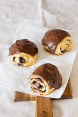 Sweet roll buns with poppy seeds covered with chocolate glaze