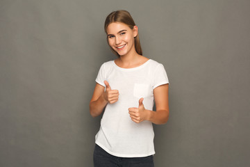 Young beautiful woman with thumbs up portrait