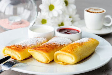 Sweet delicious pancake blinis with jam on the plate