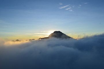 Sun Behind The Mountain Covered with Fog