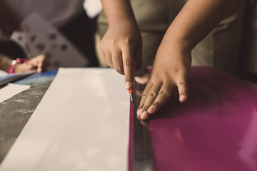 High school students are cutting prints and stickers using knife