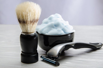 Shaving accessories. Glass table with reflections. Black background.