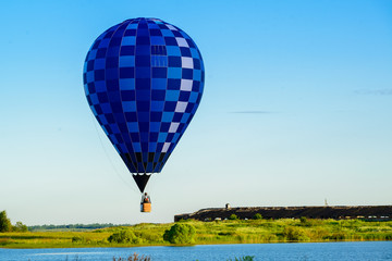 Bright colorful hot air balloon flying over lake in the clear bl © smspsy
