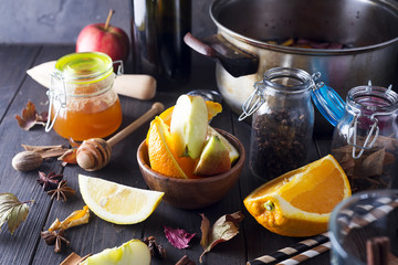 Christmas mulled wine and ingredients on dark wooden background