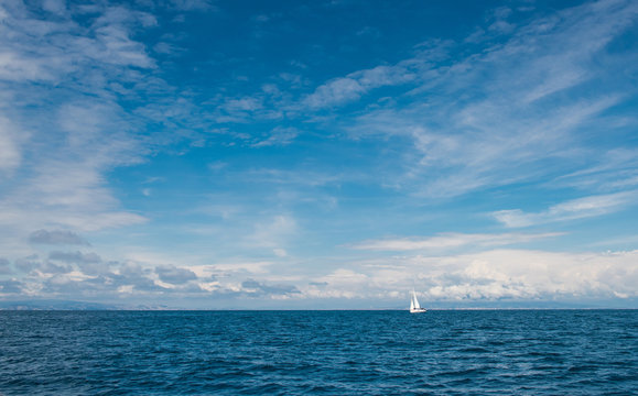  Yacht with white sails in the open sea