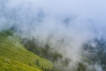 Summer scenery in the Alps with rain and mist clouds