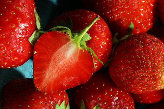 Heap of fresh strawberries on blue background