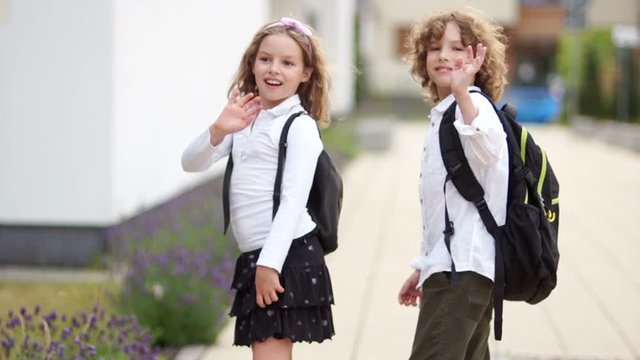 Classmates waving their hands at parting. Farewell school, last day of school, school holidays