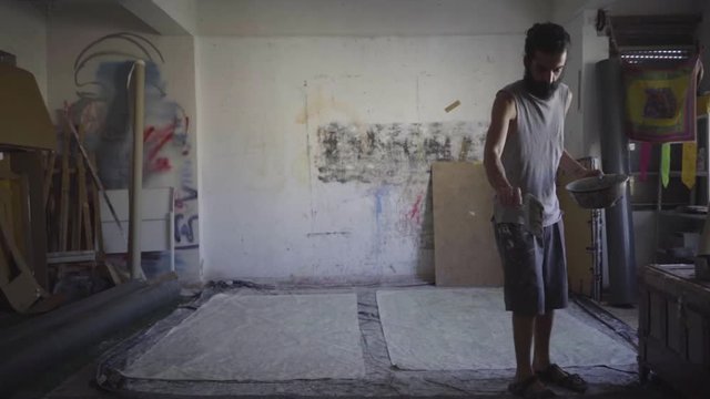 Contemporary artist working in his studio in slow motion