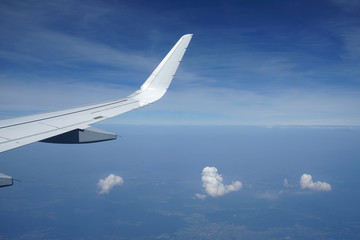 Fototapeta premium Three clouds and airplane wing.