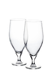 Two empty beer glasses on white