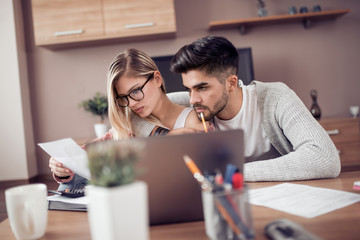 Young couple working together at home