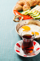 Traditional Turkish breakfast with fried eggs and tea