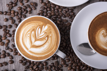 latte or Cappuccino with frothy foam, coffee cup top view on table in cafe.