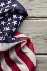 Fototapeta premium American stars and stripes flag on a white wooden plank background