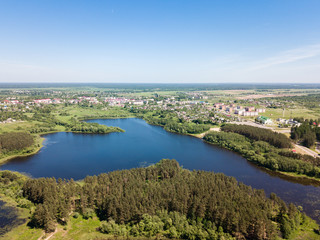 Fototapeta na wymiar Beautiful aerial view of blue lake and green forest district in 